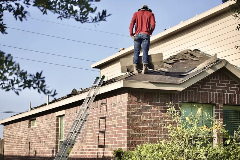 Professional roofer working on a residential roof in Jensen Beach